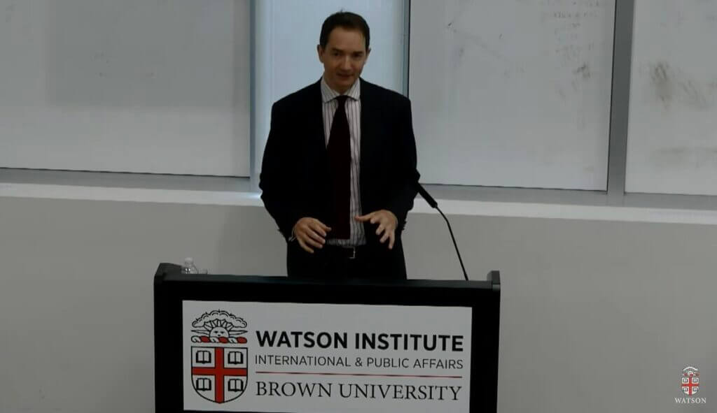 Dr. Dominic Erdozain at a lecturn.