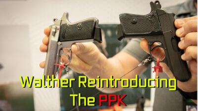 True holding up a Walther PPK and PPKs in .32 ACP.