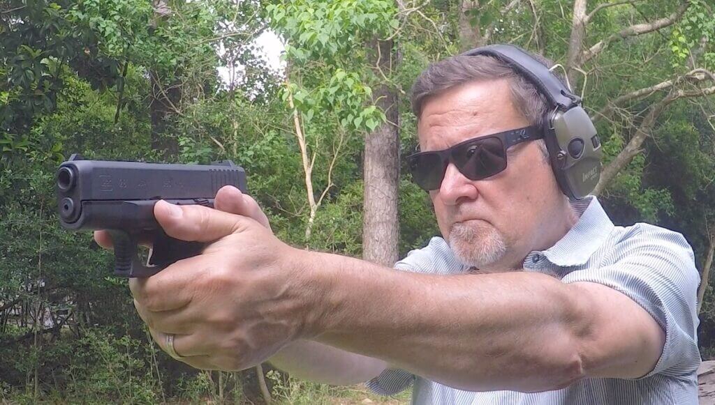 Man shooting the Glock 28 Gen 3 with his glasses and hearing protection