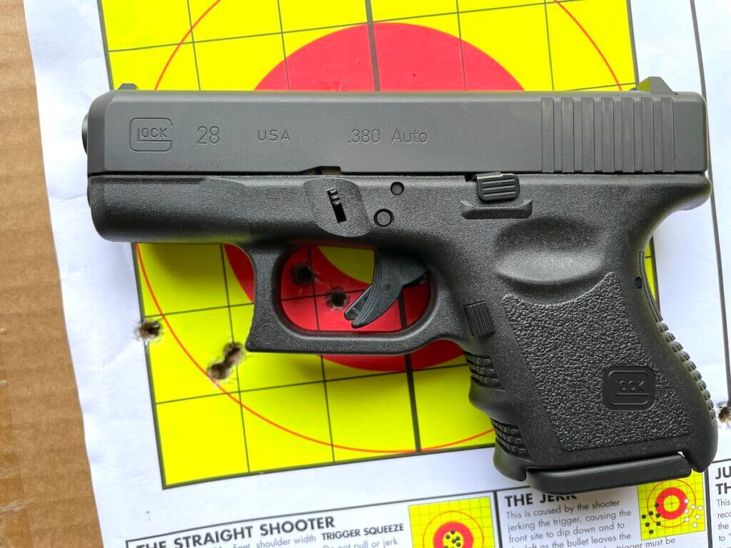 Glock 28 Gen 3 on a target with bullet holes