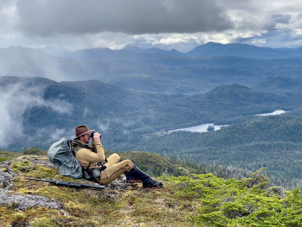 Hunter in the Alaskan mountains hunting for Sitka Blacktail deer