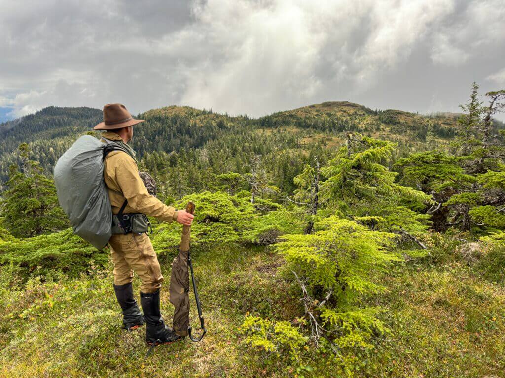 Hunter in wet Alaskan alpines looking for deer