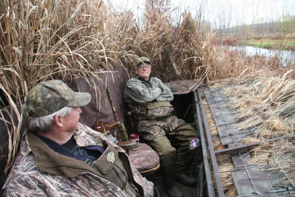 Hunters sitting and not paying attention to footwork in blind