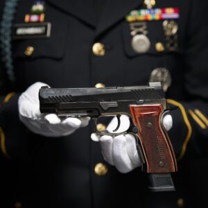 A soldier holding a SIG P320-M17 Ceremonial.