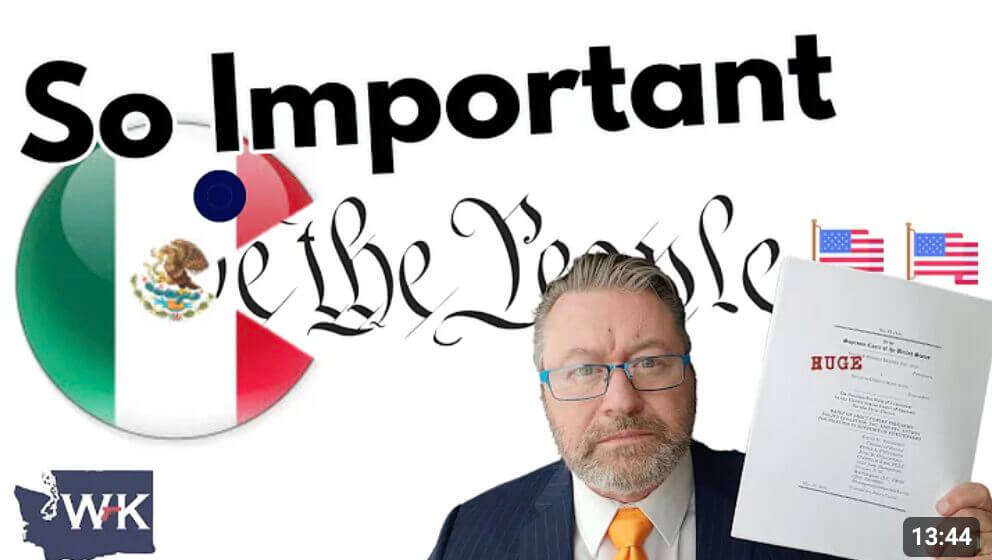 William Kirk holding up an amicus brief.