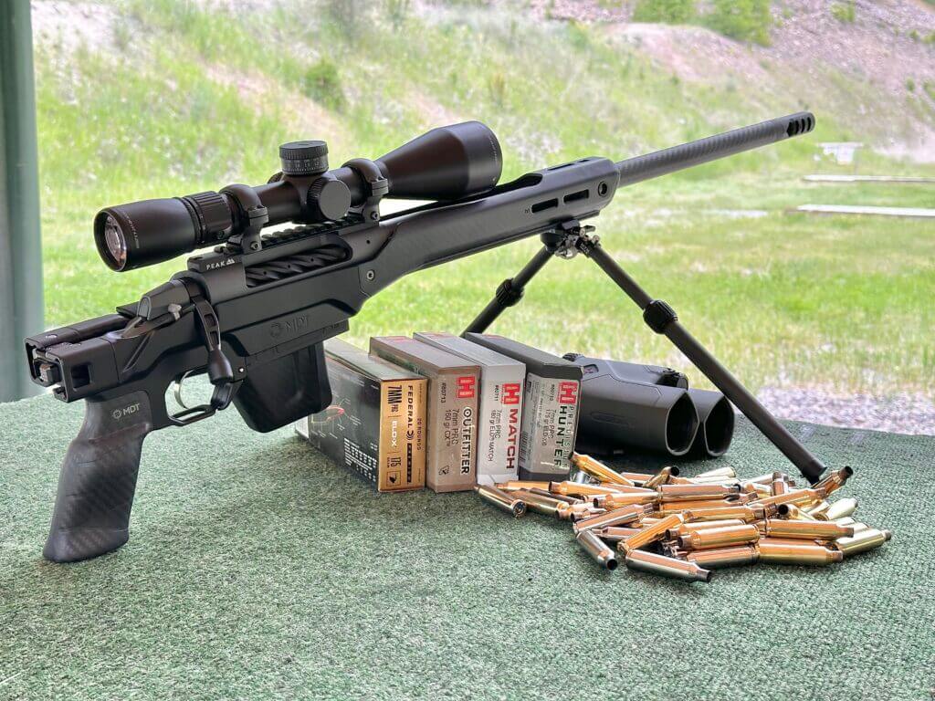 Weatherby Model 307 rests on bipod at shooting range with pile of ammo