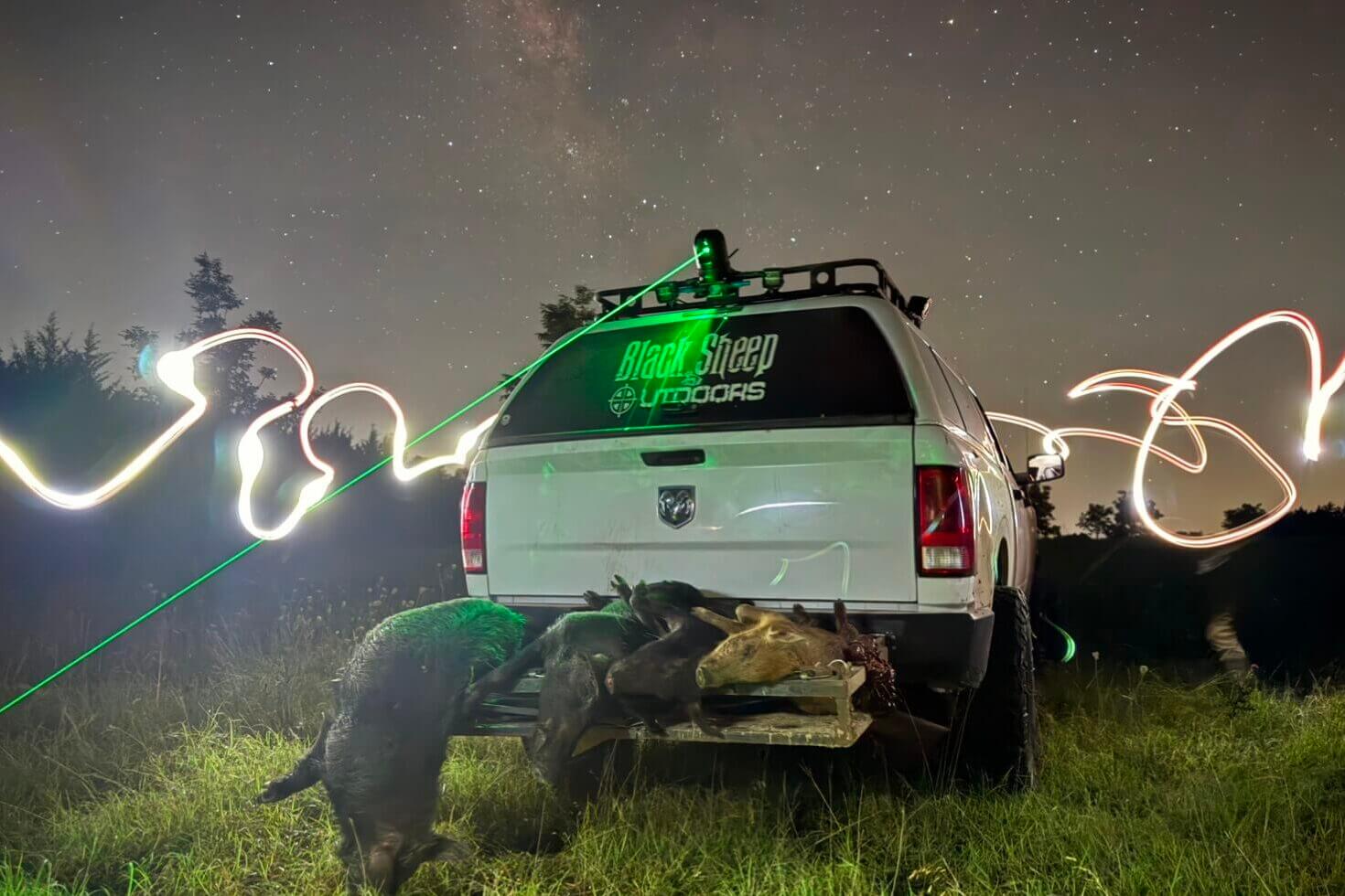 White truck with stickers loaded down with game, green and white lights showing from InfiRay Outdoor M6T