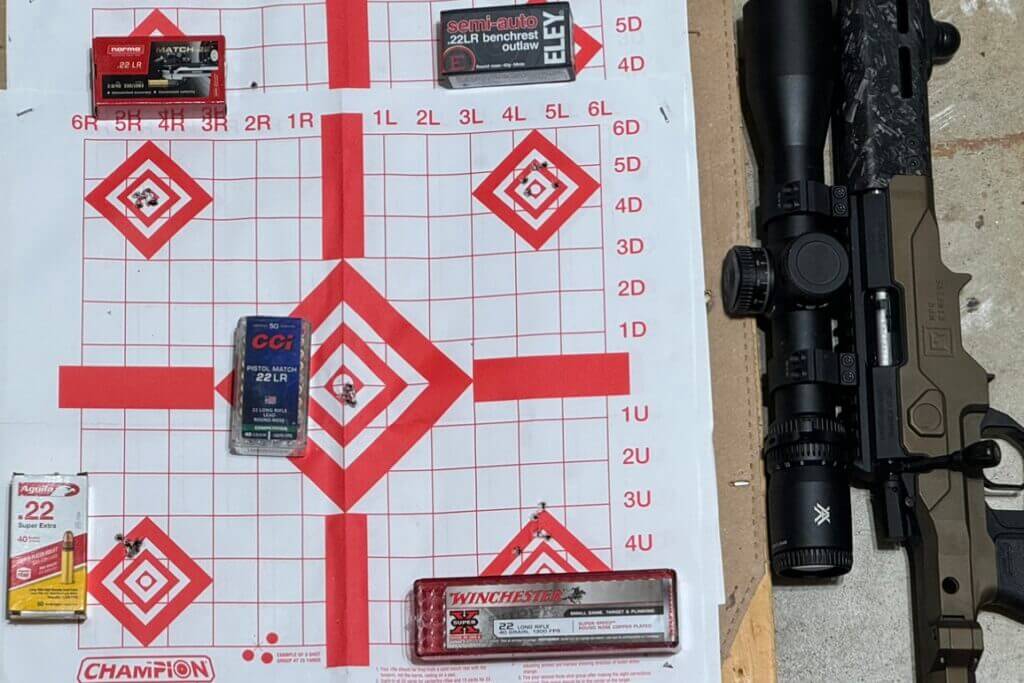 MPR Rimfire rifle next to paper target and variety of ammo