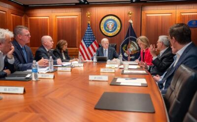 A white house briefing room with Kamala Harris and President Joe Biden.