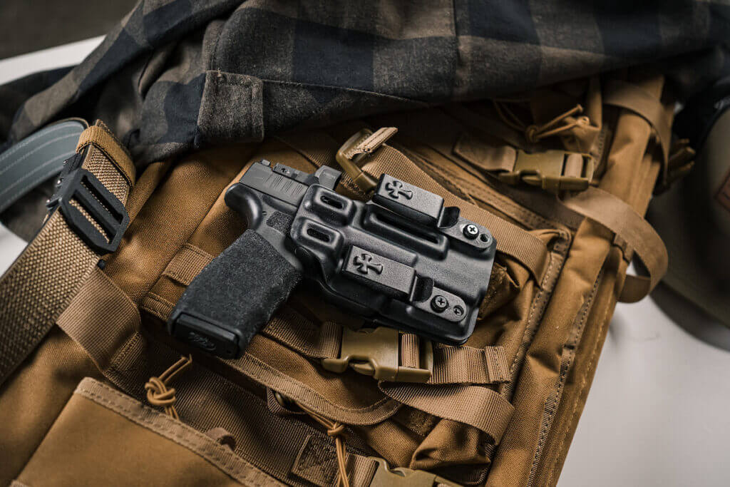 CrossBreed's all-new Reign IWB holster on a backpack.