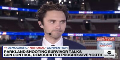 David Hogg with a headset on, speaking to ABC News.