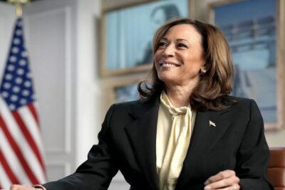 Kamala Harris sitting at a desk.