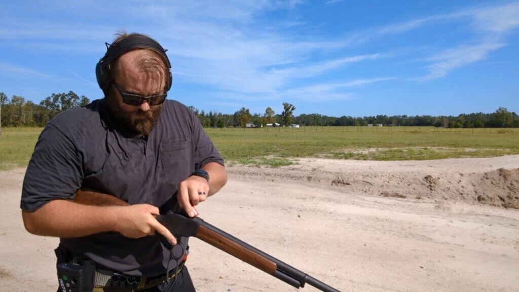 Man working on gun at range