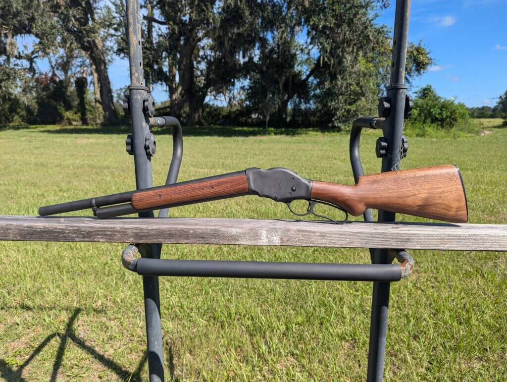 Historic wooden gun on wooden platform in front of field