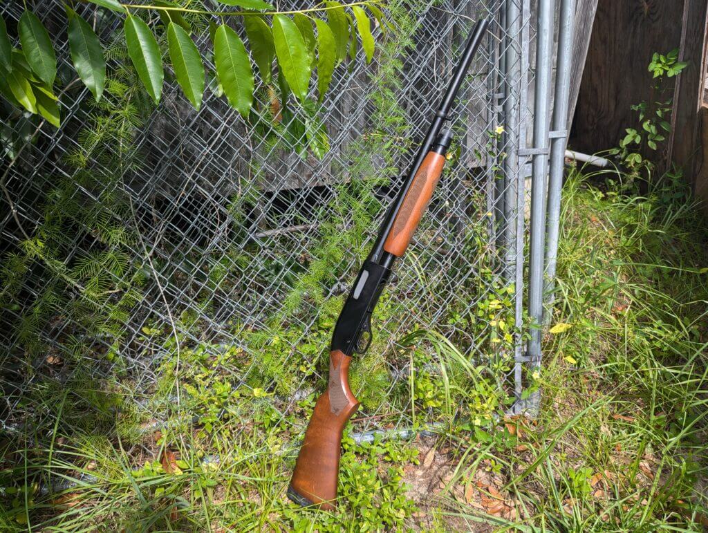 Speed pump shotgun leaned against wire fence