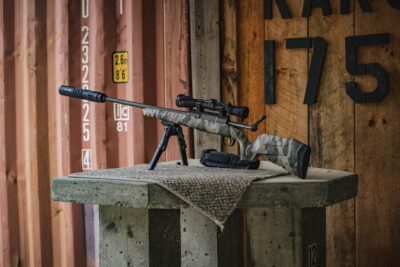 A Savage Axis rifle on a bench at a shooting range.