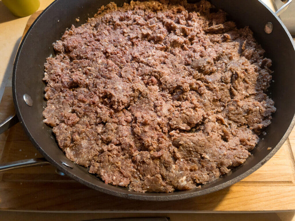 Venison sausage in a frying pan