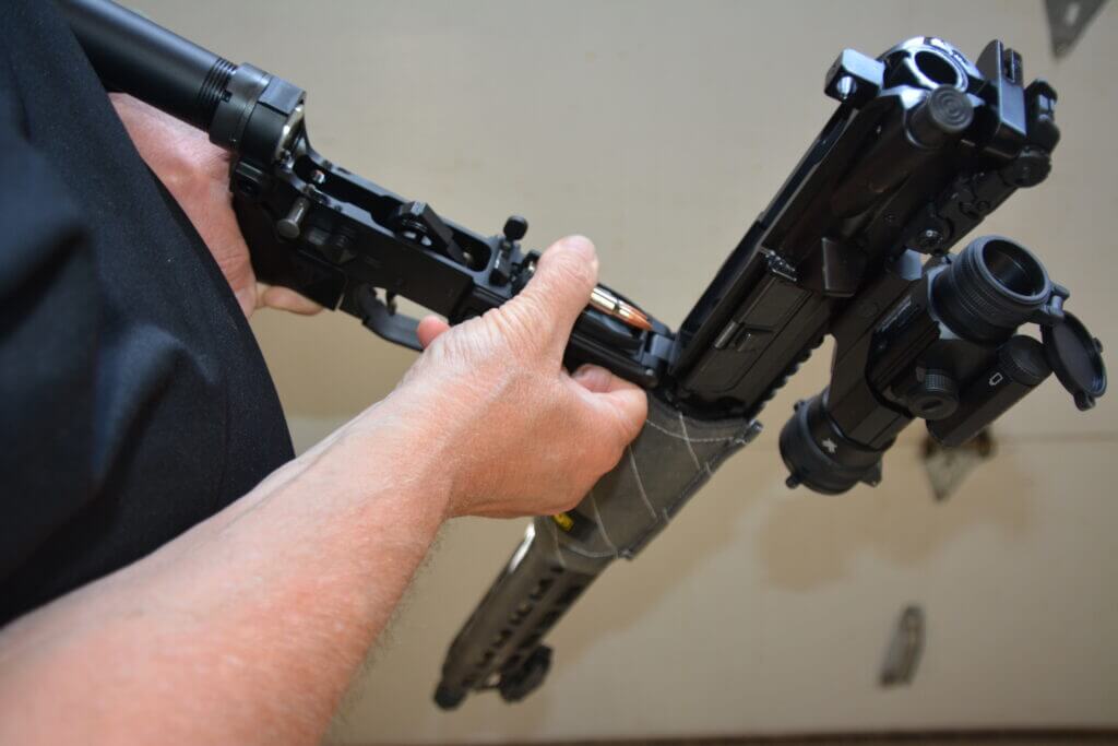 Loading the 10-Round Magazine from the open top of the receiver.