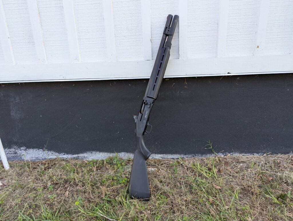Mossberg 940 Pro Tactical semi-auto shotgun staged upright