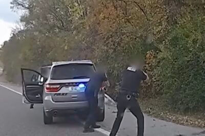 Cops surround the suspects vehicle.