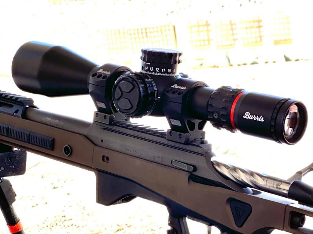 A rifle scope is mounted on top of a bolt action rifle.