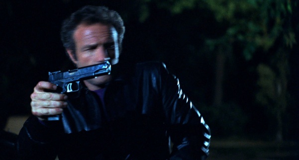 James Caan in thief holding pistol