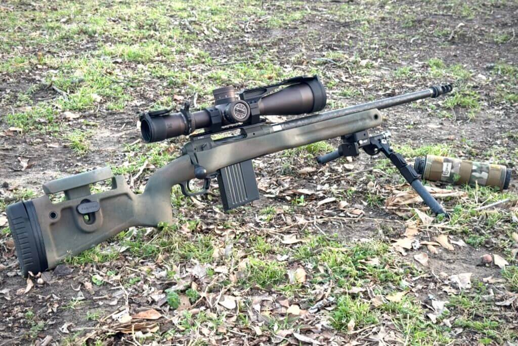 Camo Savage 110 PPR with scope and bipod set in grass