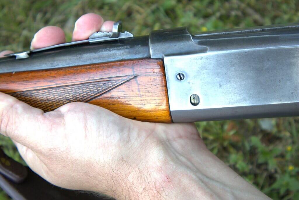 man hand holding vintage rifle