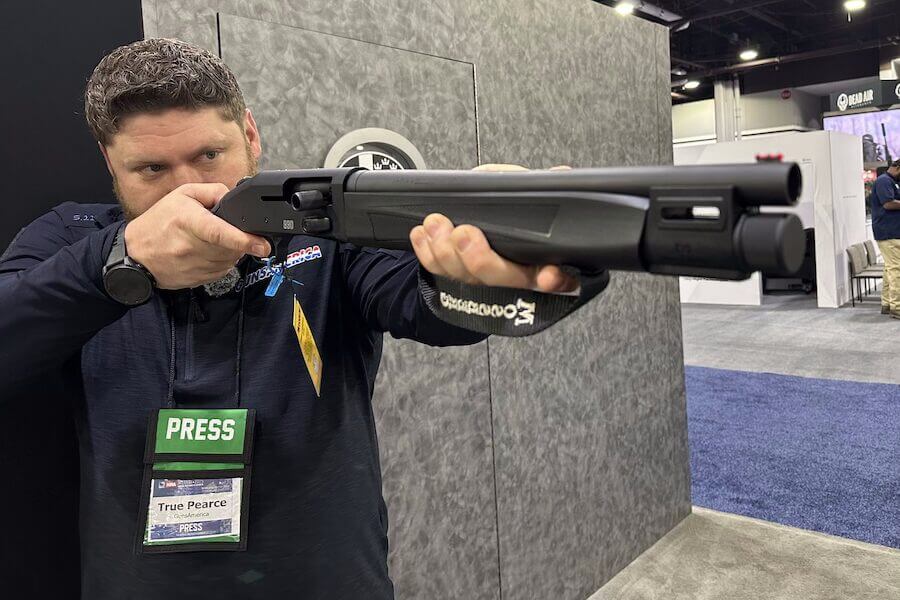 True holding up and pointing a Mossberg Aftershock.