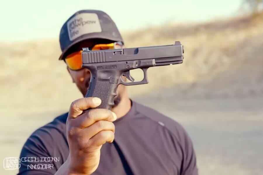 Colion Noir holds up a Glock 17.