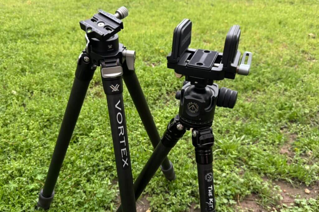 Two tripods sitting on grassy lawn