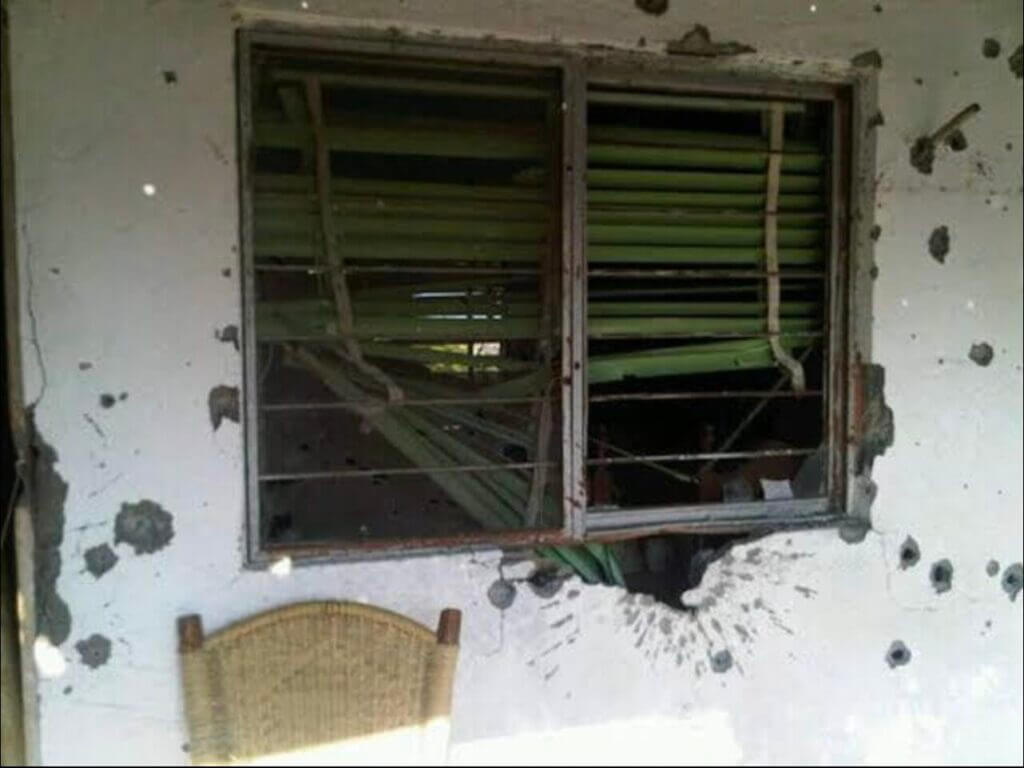 home of Alejo Garza Tamez with visible bullet holes and shrapnel pattern