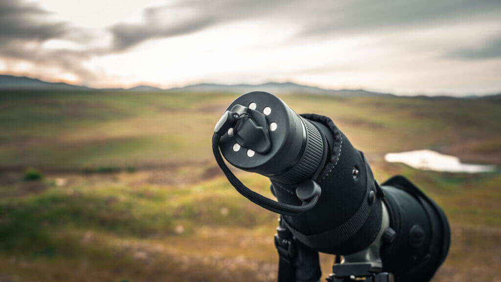 magnetic lens cover on a spoting scope