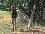man shooting compound bow