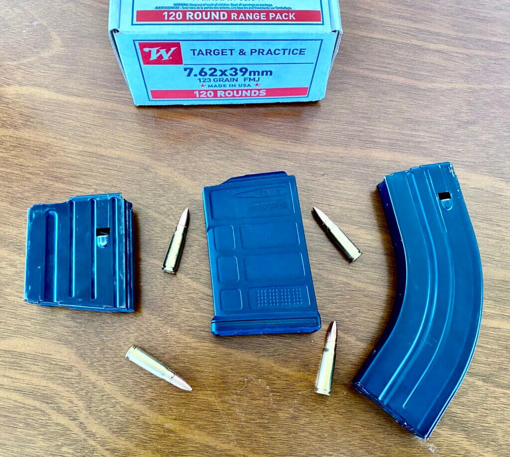 three different rifle magazines with some ammo