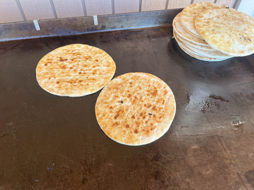 Pitas warming on a griddle.