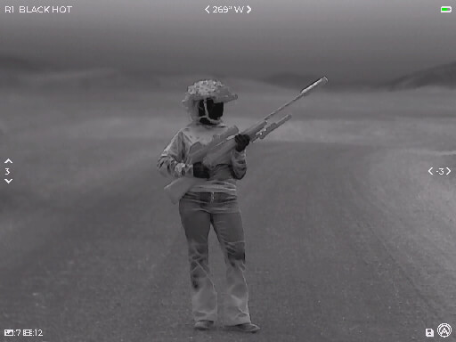 thermal image of a woman holding a rifle 