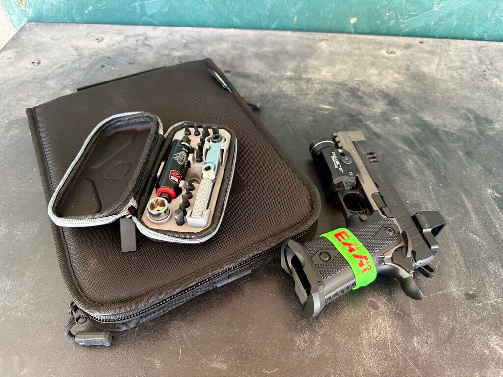 Girsan Match X lays on the table next to the Real Avid Smart-Torq kit while at the gun range.