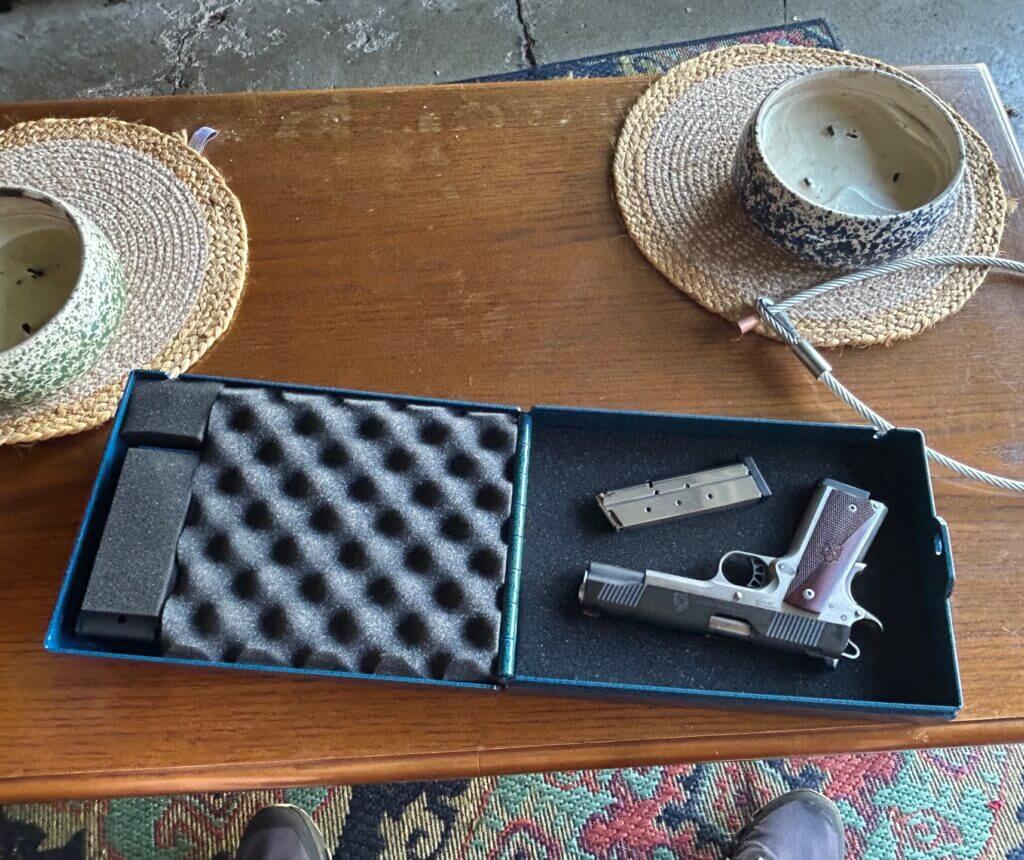 Steelhead lock box open on a table with Springfield Ronin 1911 and magazine inside.
