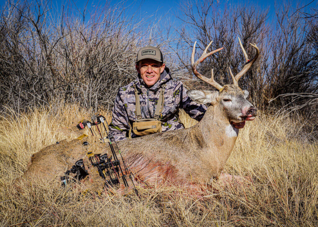 man with a dead deer