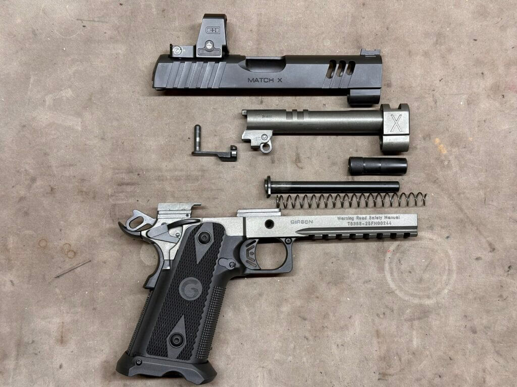 A disassembled handgun is laid out on the tan tabletop.Witness2311 Match X