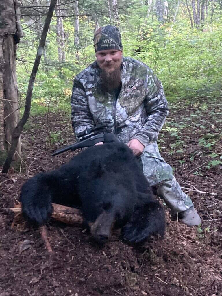 Hunter Adam with his successful handgun black bear taken in Maine