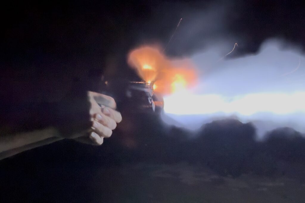 Shooter running S&W Carry Comp with TLR-1 HP-X during after dark range session