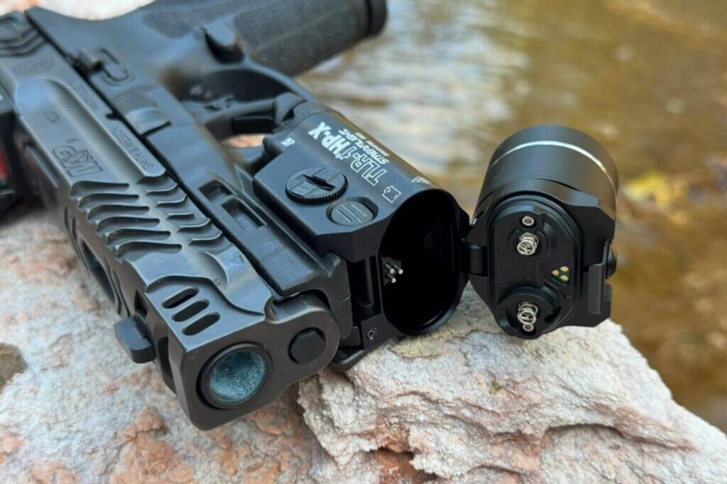 Hinged front cap of TLR-1 HP-X pivoted for battery access