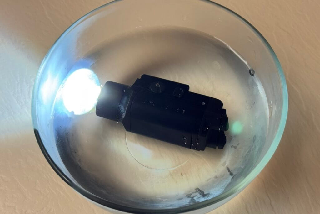 Nitecore NPL35 submerged in freezing water during waterproof and cold weather durability testing
