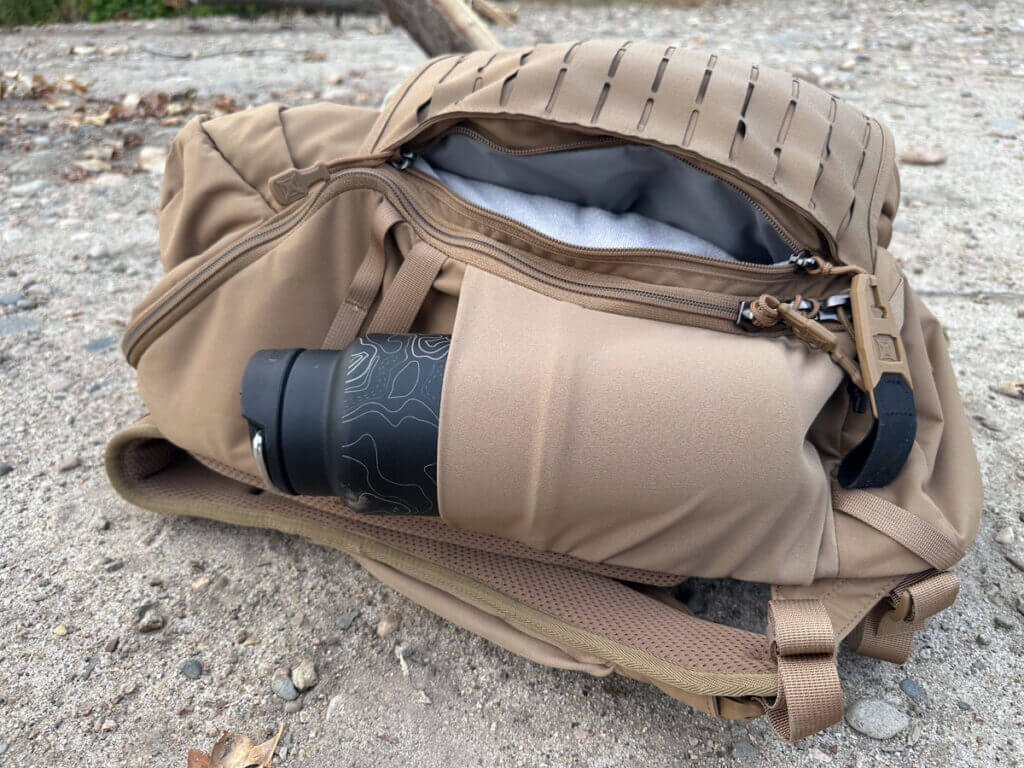 Vertx Siege 25L Tactical Backpack side pocket holding a large water bottle