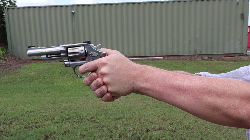 Shooter firing the Smith & Wesson 617 Mountain Gun .22 LR revolver offhand on the range