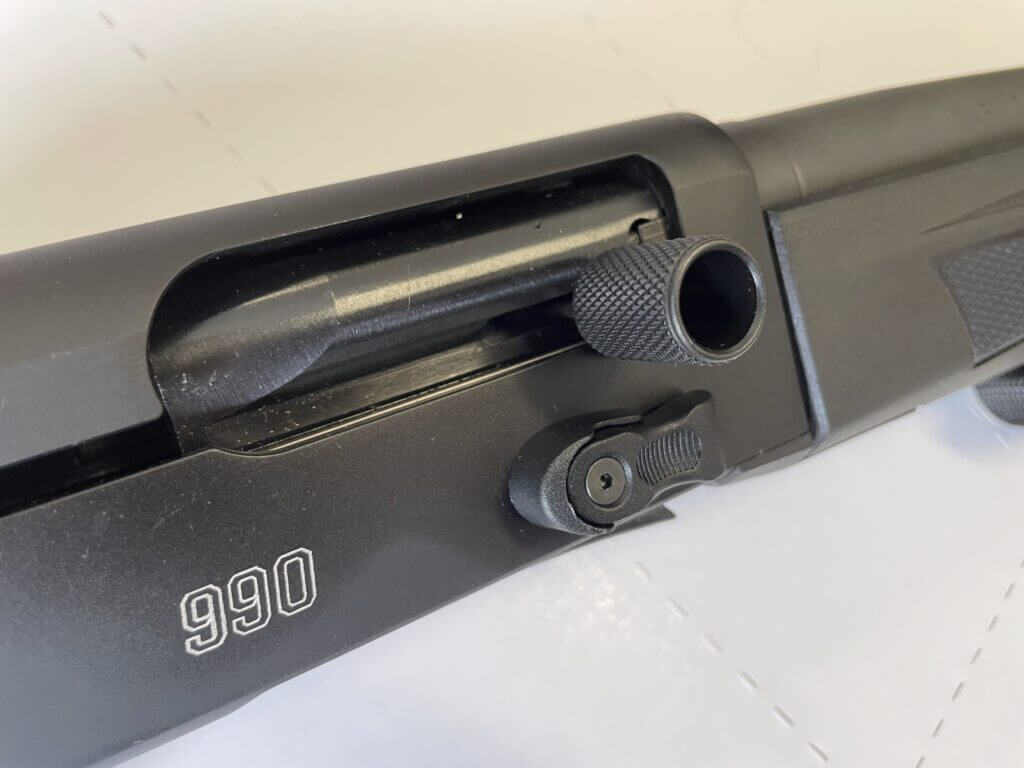 Mossberg 990 Aftershock oversized bolt release and charging handle closeup