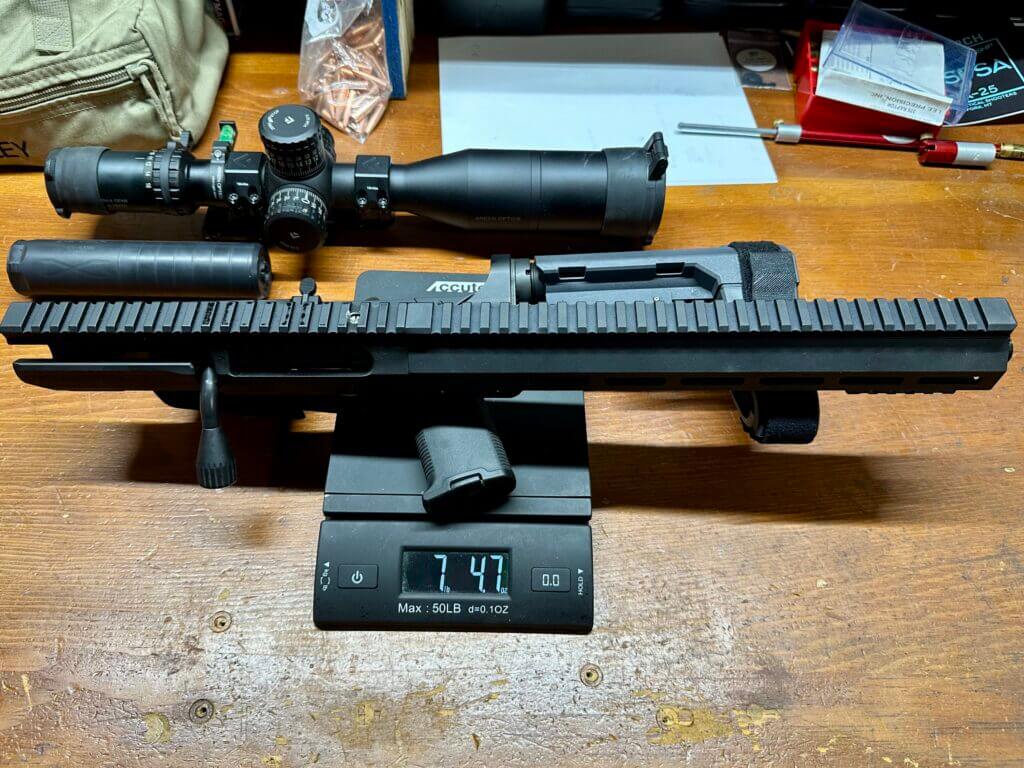 UP-10 12.5 inch 8.6 Blackout separated upper and lower on scale showing 7 lb 4.7 oz weight.