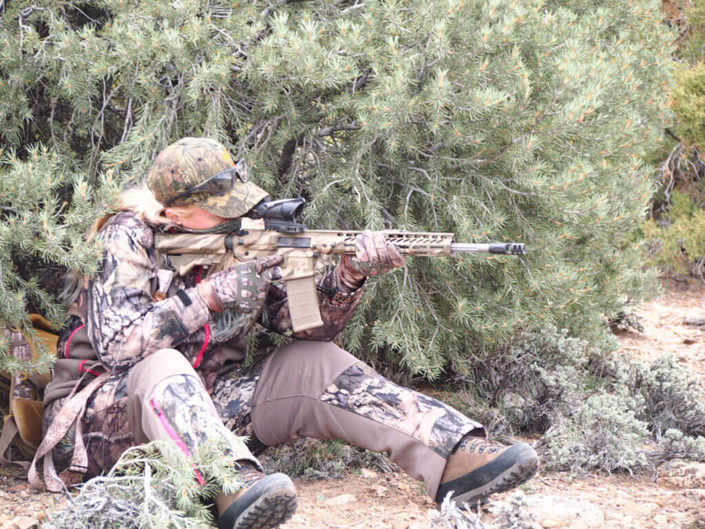 AR-15 hunting rifle carried in open desert terrain during a hunt